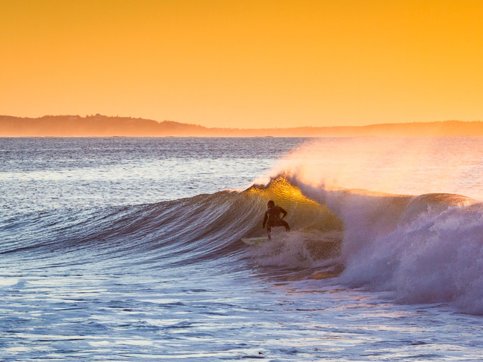 Surfer riding a wave, Nova Scotia